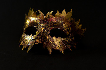 Cosplay, Venetian mask in gold and red with metallic pieces in the form of leaves. original and unique design, handmade crafts