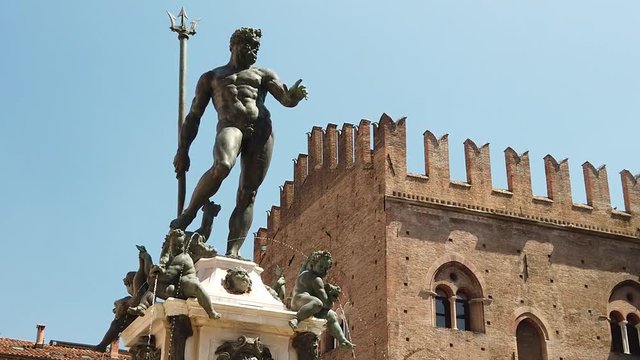 SLOW MOTION: Neptune 1567 bronze statue and fountain in front of Accursio palace of Bologna city in Emilia region of Italy.