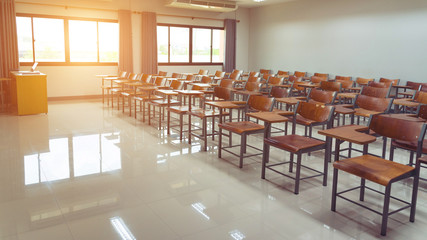 Empty university classroom with wooden chairs and desks. Modern university lecture room without student. Empty university classroom