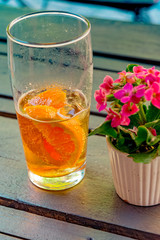Caffeinated cold drink with mate extract, orange slices and ice cubes