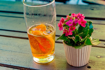 Caffeinated cold drink with mate extract, orange slices and ice cubes