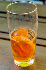 Caffeinated cold drink with mate extract, orange slices and ice cubes
