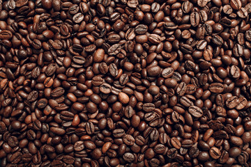 Roasted coffee beans brown seeds texture background wallpaper. Top view.