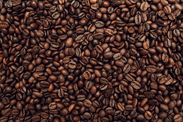 Roasted coffee beans brown seeds texture background wallpaper.
