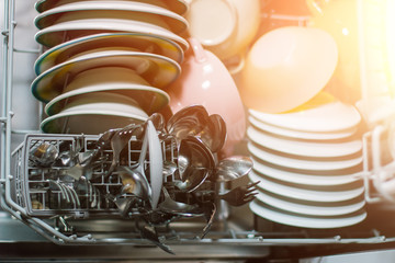 Open dishwasher with clean glass and dishes, selective focus, Clean after washing in the...