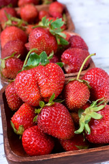 Fresh organic strawberries in little wooden bowls