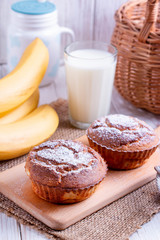 Obraz na płótnie Canvas Homemade banana muffins on the wooden table