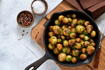 Fried, young potatoes with spices in a pan. View from above.