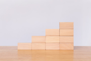 Wooden cube stack a staircase on white background. Concept of success, winner, victory or top ranking