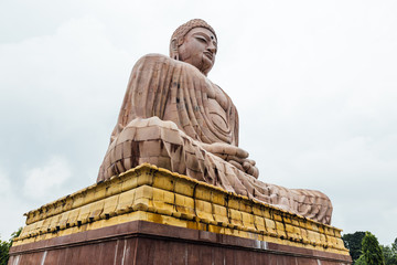 Daibutsu, The Great Buddha Statue in meditation pose or Dhyana Mudra seated on a lotus in open air near Mahabodhi Temple at Bodh Gaya, Bihar, India