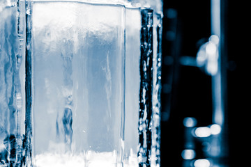 Textured frosty crystal clear ice blocks isolated on black background with copy space.