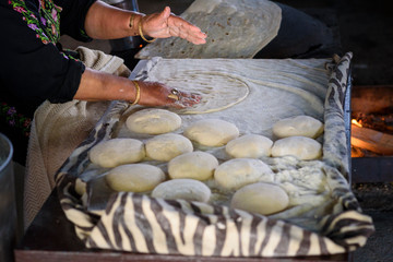 Close up of old Arab woman hands kneading fresh dough for Taboon bread or Lafah is a Middle Eastern...