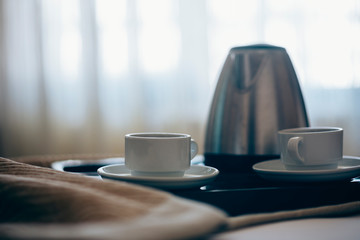 Morning breakfast with black coffee in bedroom.