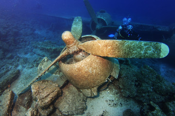 scuba diver search plane crash site motor unit in dramatic light