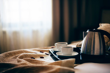 Morning breakfast with black coffee in bedroom.