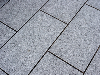 Concrete rectangle tile pavent sidewalk on city streets in Japan