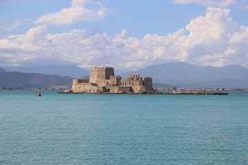 In the bay of Nafplio, Peloponnese, Greece. Bourtzi castle and mountain landscape. South-east Europe.