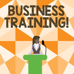 Word writing text Business Training. Business photo showcasing increasing the knowledge and skills of the workforce Businesswoman Standing Behind Podium Rostrum Speaking on Wireless Microphone