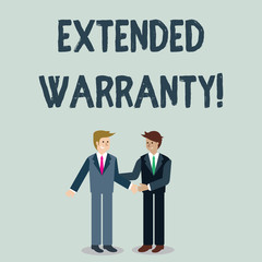 Writing note showing Extended Warranty. Business concept for contract which gives a prolonged warranty to consumers Businessmen Smiling and Greeting each other by Handshaking