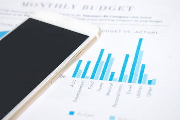 Image about financial graph. Modern office desk image,, smartphones on the financial graph of businessmen