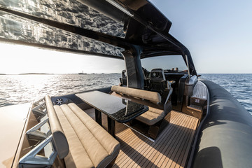 Fototapeta premium view on inflatable motor boat at sunset