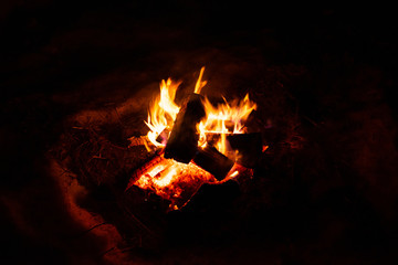 Close up of campfire burning with large flames in cold winter polar night, on a black background. Warm Winter snow outdoor scene in Tromso, Norway