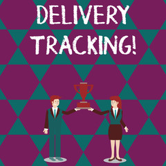 Text sign showing Delivery Tracking. Business photo text the process of localizing shipping containers and mails Man and Woman in Business Suit Holding Together the Championship Trophy Cup