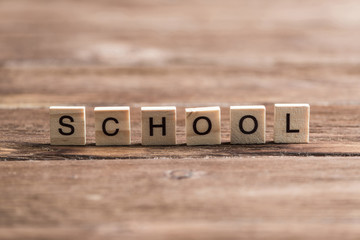 wooden elements with letter collected to word school