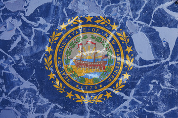 The national flag of the US state New Hampshire in against a gray wall with cracks and faults on the day of independence in blue and yellow. Political and religious disputes, customs and delivery.