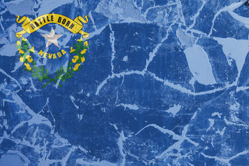 The national flag of the US state Nevada in against a gray wall with cracks and faults on the day of independence in colors of blue and yellow. Political and religious disputes, customs and delivery.