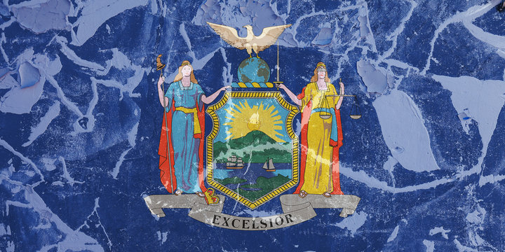 The national flag of the US state New York in against a gray wall with cracks and faults on the day of independence in blue and yellow. Political and religious disputes, customs and delivery.