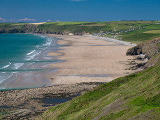 Newgale Beach in Pembrokeshire, taken from the Coast Path in summer aganst a blue sky