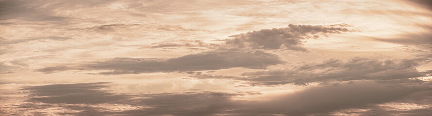 vibrant golden clouds are rolling into the horizon panorama