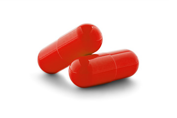 Two medical pills on white isolated background with shadow.