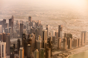 Downtown aerial view of Doha, Qatar taken through tilt shift lens.