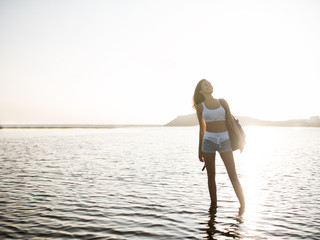 Fototapeta premium Happy carefree sportly woman enjoying beautiful sunset on the beach