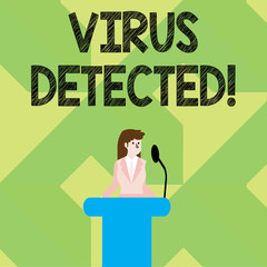 Writing note showing Virus Detected. Business concept for Identified a malware that possible can harm the computer Businesswoman Behind Podium Rostrum Speaking on Microphone