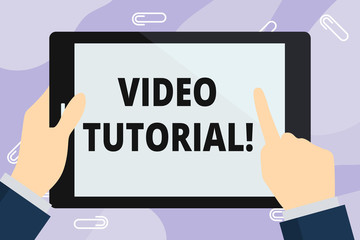 Obraz na płótnie Canvas Handwriting text writing Video Tutorial. Conceptual photo method of transferring knowledge through audiovisual clips Hand Holding Pointing Touching Blank Rectangular Color Tablet White Screen