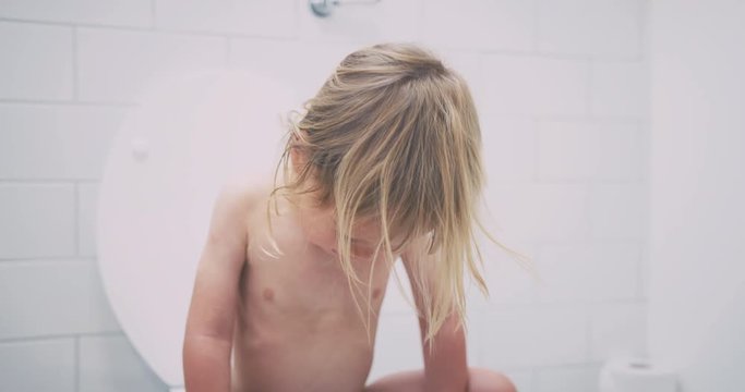 Little toddler sitting on the toilet