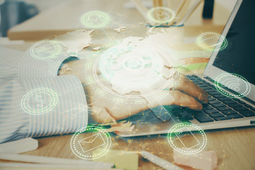 Social network theme hologram with businessman working on computer on background. Concept of world...