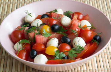 Salad with tomatoes, olives and mozzarella cheese