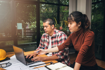 Group of two coworkers working with blueprint in office. co-working teamwork concept.