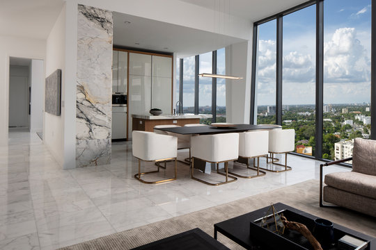 Miami Apartment looking from Living Room to Kitchen with floor to ceiling windows. 