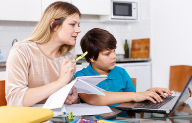 Fototapeta premium Family doing homework at kitchen