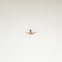 Airplane flying in the sky at sunset. Travel, vacation and holiday concept. Vintage and retro tones filter. Minimalistic background.