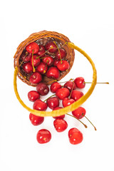 Basket of fresh sour cherries isolated on white