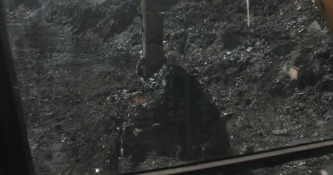 Slow motion loading of an excavator into mining truck. Excavator loading coal in big dump trucks. Coal as source of thermal energy. Loading of coal truck using excavator slow motion