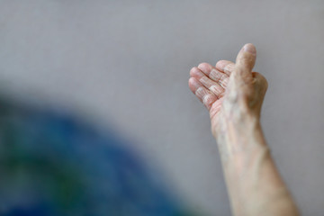 Elderly woman, wrinkled hand palm. Old lady's hand. Elderly lady is waiting for help. Elderly concept with light background.