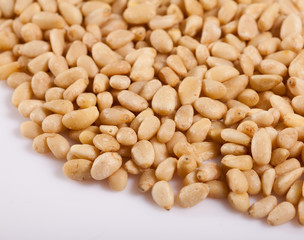 Pile of delicious pine nuts on a white surface