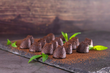 Homemade chocolate truffles with mint sprinkled with cocoa powder